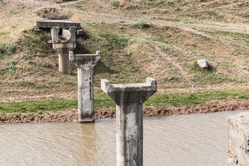 Concrete columns of an old broken aqueduct over an irrigation canal in the Chui region of...