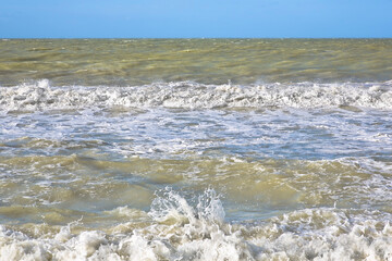 The rough sea - Storm surge with waves, foam and muddy water