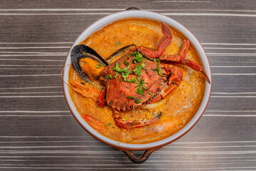 It is usually made in a clay pot, with a base of seafood and broth