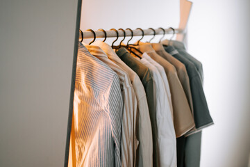 Collection of neatly arranged shirts hanging on a rack in a well-lit room