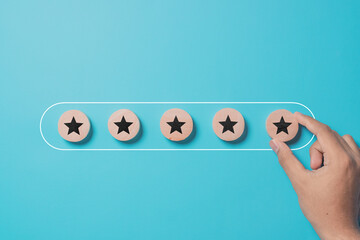 Improve rating, increase ranking, improve customer satisfaction concept. Hand putting wooden blocks with star icon in progress bar on turquoise background
