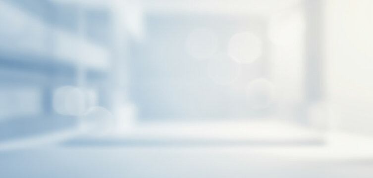 Blurred interior space with light blue and white tones creating an abstract background that showcases a minimalist yet functional design, ideal for clinical or modern healthcare settings. - Powered by Adobe