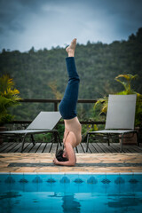 Woman Practicing Headstand by the Pool in Brazil
