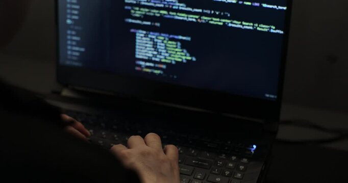 Young woman, developer programmer, software engineer, IT support, working hard at night overtime on computer.