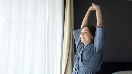 Woman stretches stepping to window soaking morning tranquility
