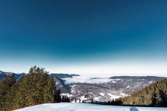 winter landscape in the mountains with snow, blue sky, trees and sun star - Powered by Adobe