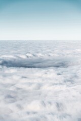 winter mountain landscape with snow, fog and cloud covered areas