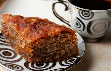 Traditional Turkish baklava dessert with dates, elegantly served on a pink plate.