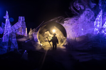 A silhouette of a person against the background of shattered glass. An abstract world made of glass shards. Surreal concept. Table top decoration.