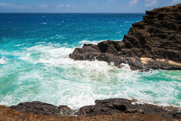 Scenic view of Halona Cove, Oahu, Hawaii, USA against Pacific Ocean and blue sky with clouds