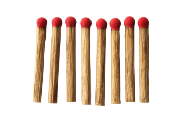 A close up view of seven wooden matches with red tips arranged in a row on a black background