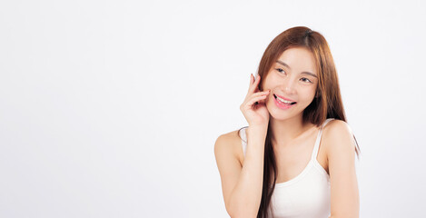 Fototapeta premium Skin radiance and glowing skin captured in this portrait of an Asian woman with gentle hands touching her face, reflecting softness and natural beauty isolated studio white background