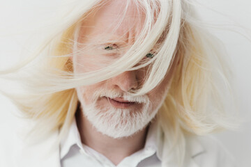 Man with flowing white hair and beard, against a soft white background, exuding a serene and...