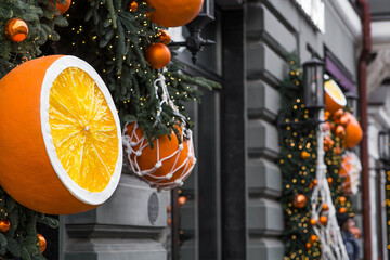 Christmas background. Tangerines in a string bag and Christmas tree toys on the streets of Moscow....