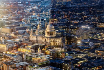 Conceptual day and night view of the illuminated St. Pauls Cathedral and skyline in London, England