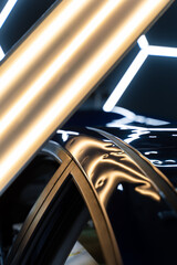 Car panel shows multiple dents under PDR lighting, used in paintless dent repair to expose...