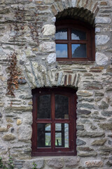 small windows in the wall of a stone castle