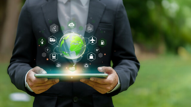Green logistic concept. Business man hold a tablet with a globe, symbolizing green logistics and eco-friendly transport solutions. Sustainable methods to reduce environmental impact in supply chains.