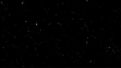 Chaotic white bokeh on a black background with small falling snowflakes. Snow storm effect,