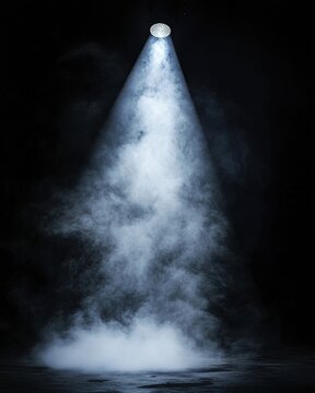 Dramatic lighting beam shining through atmospheric smoke against dark background