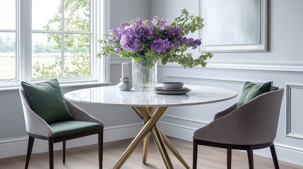 Round dining table with brass legs and white marble top in cozy corner nook with light gray walls, green pillows, purple flower vase, and natural window light.