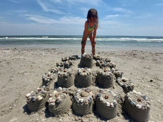 Kid building a sand castle on the beach