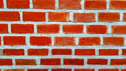 High resolution image of a red brick wall with visible white mortar lines