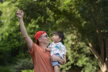 Dad is teaching his son about wording around nature