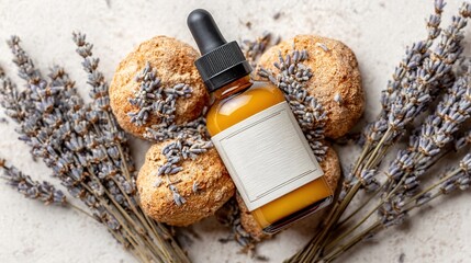 Essential oil bottle with blank label surrounded by dried lavender flowers and bath bombs
