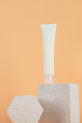 Plastic white tube for cream or lotion. Skin care or sunscreen cosmetic with stylish props on cream...