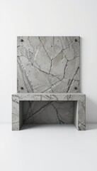 A modern concrete chair with a matching backrest. The design features a smooth surface with a gray marble pattern. The setting is minimalistic and contemporary.