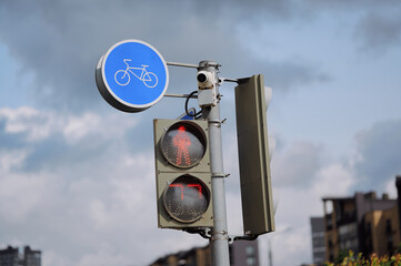 urban bicycle sign and traffic lights against cloudy sky, highlighting infrastructure and safety. illustration of city transportation and modern traffic management systems