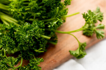Closeup of parsley herb on a wooden cutting board