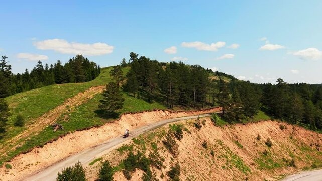 A retired couple is riding their bicycles through the heart of nature.