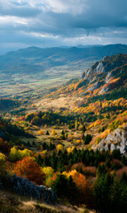 Breathtaking autumnal panorama capturing the serene beauty of colorful forests and majestic mountain ranges under cloudy skies