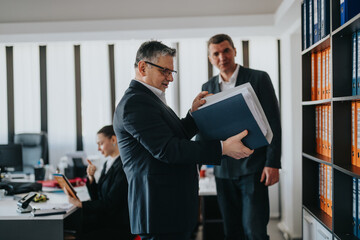 Teamwork and organization among colleagues working together in a professional office setting