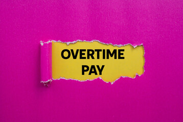 Overtime pay message written on ripped torn pink paper on yellow background. Conceptual overtime pay symbol. Copy space.
