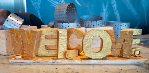 Welcome Gold Word Displayed on Bakery Buffet