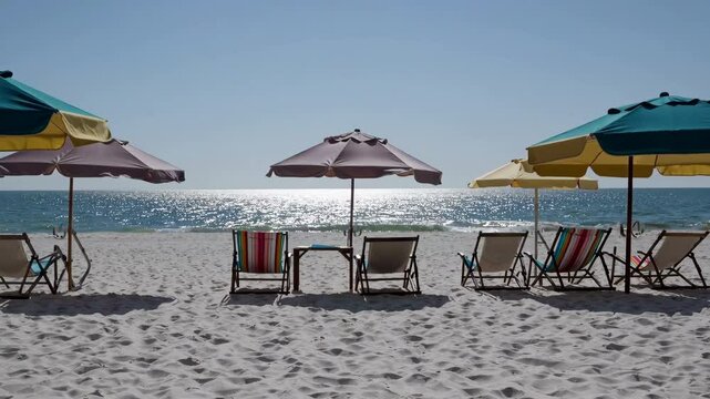 Colorful Beach Chairs and Umbrellas Facing the Ocean on Hilton Head Island, South Carolina Under a Bright Blue Sky