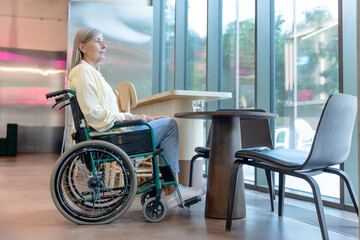 Caucasian mid aged woman on a wheelchair in a rehabilitation center