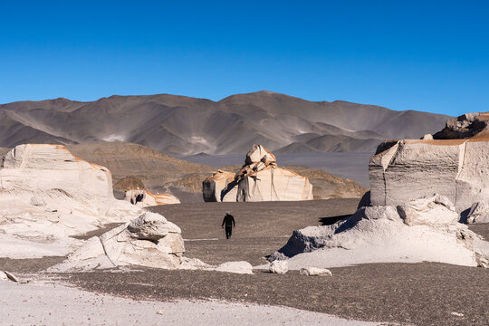Man exploring pumice stone field in La Puna, Argentina