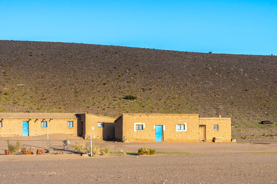 Traditional adobe houses under clear sky in La Puna