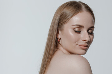 Natural beauty portrait of woman with sleek hair and subtle makeup in a minimalist setting
