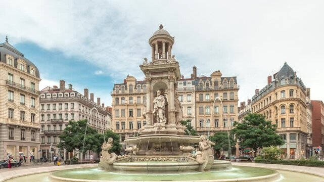 Hyperlapse of Place des Jacobins in Lyon, France, featuring the ornate Fontaine des Jacobins surrounded by historic buildings. Bustling city square under a cloudy sky timelapse