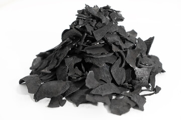 Pile of coconut shell charcoal derived from natural coconut shells