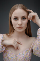 Model poses elegantly with a soft gaze during a fashion shoot in a studio setting