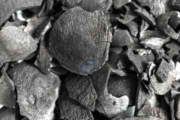 Pile of coconut shell charcoal derived from natural coconut shells