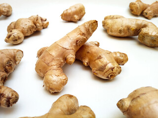 Fresh ginger roots or ginger rhizome on white background
