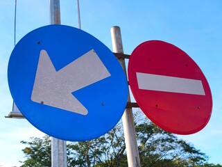 Directional sign side by side with the no entry sign