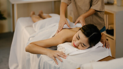 Relaxed lady enjoy body massage at spa with closed eyes. Wellness concept